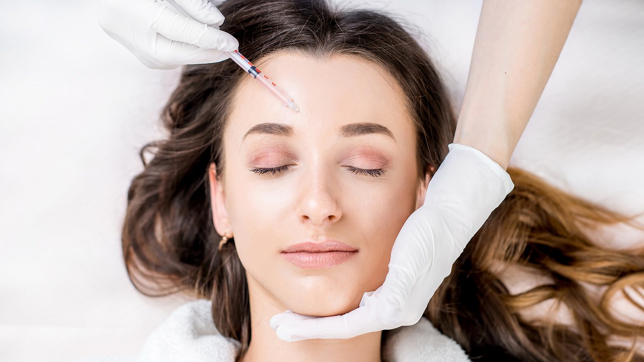 Woman undergoing botox face injection